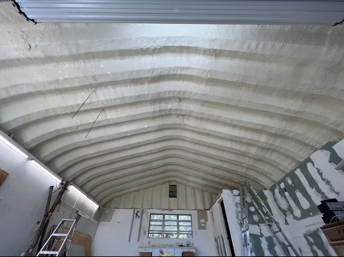 Spray polyurethane foam applied to the underside of a metal roof deck in Lemoore Station